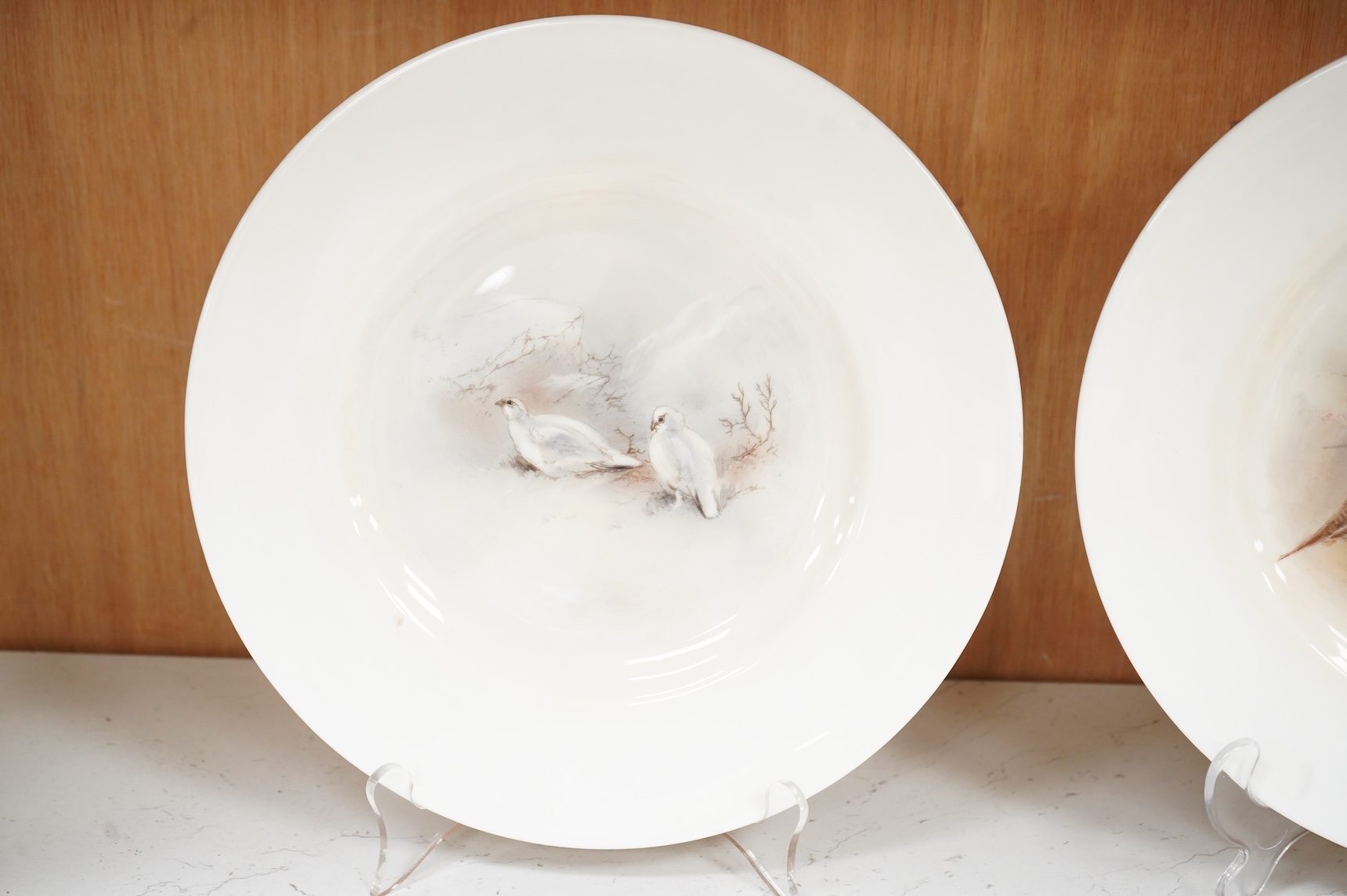 James Stinton for Royal Worcester, a pheasant painted plate, signed and a similar but unsigned ptarmigan plate
